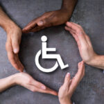 Close-up Of A Hands Protecting Disabled Handicap Icon